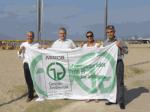The flag of the ISO 14001 waves on the beach of Levante